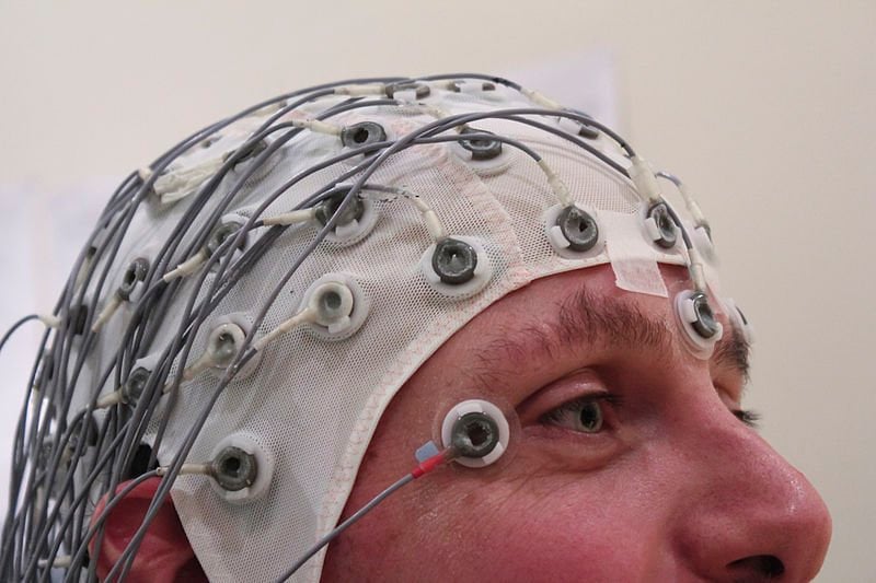 The image shows a person using EEG.