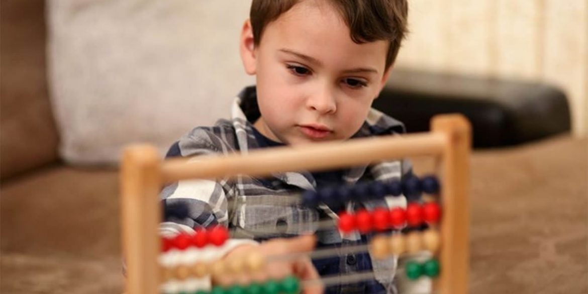 This shows a child with an abacus