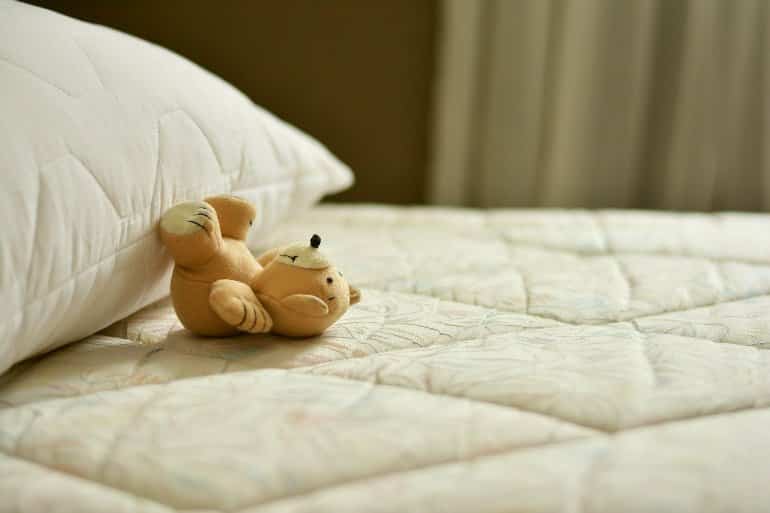 This shows a teddy bear on a bed